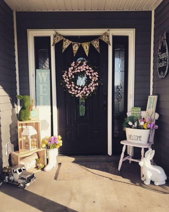 Easter Planter arrangement with a wreath on a porch #easter #backyardporch #porchIdeas #frontDoorDecor #frontDoorWreaths #frontDoorWreath