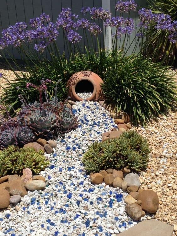 Dry river bed landscaping ideas:flowering bush that hugs a pot