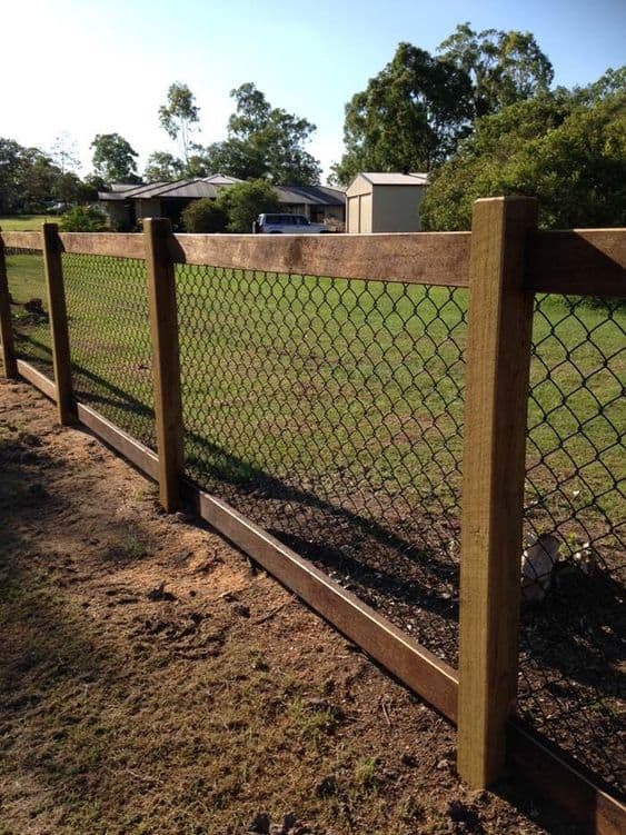 wood and metal fence to separate yard from the garden