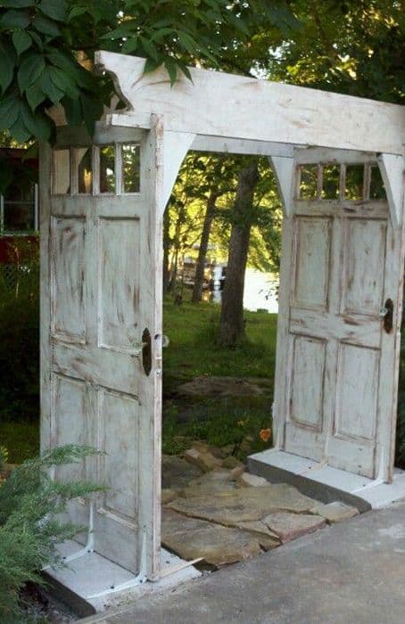 old doors recycled into an arbor #arbor #backyardLandscaping #backyardLandscapingIdeas #landscaping #cheapLandscapingIdeas #backyard #landscaping #pergola