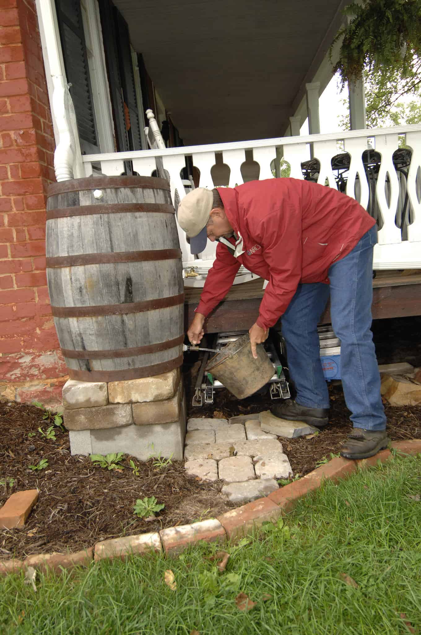 A man pouring rain water in a bucket #rainWater #garden #gardening #gardenTips #gardencare #gardenTools