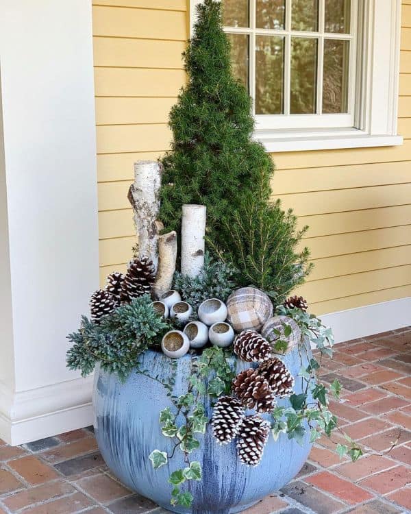 Planter decorated with woodlogs, leaves and pine cones