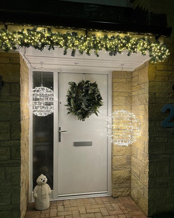 Front door decorated with string light balls