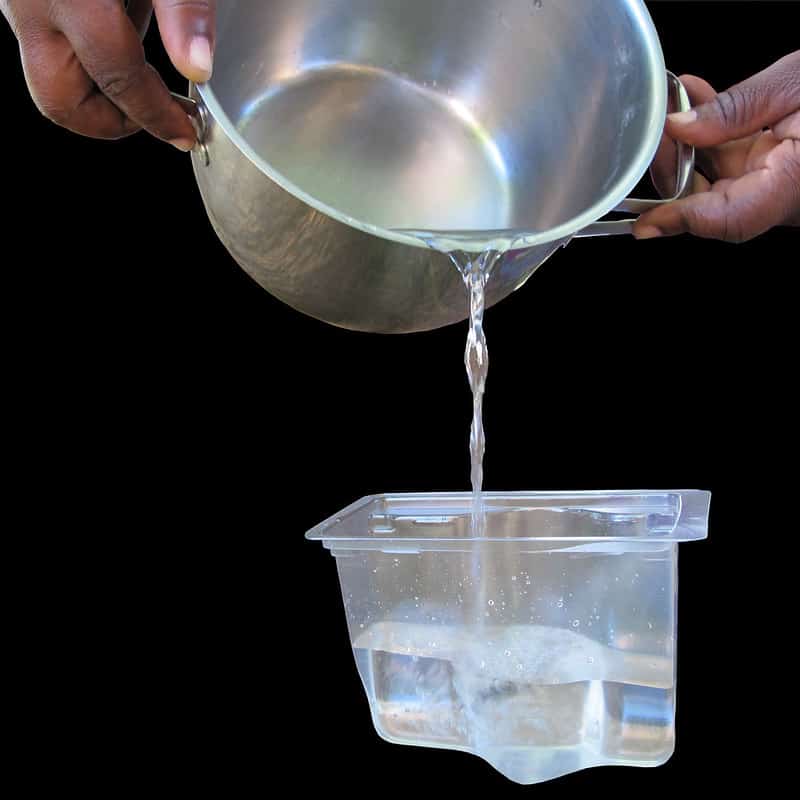 A small basin with water poured in a plastic container