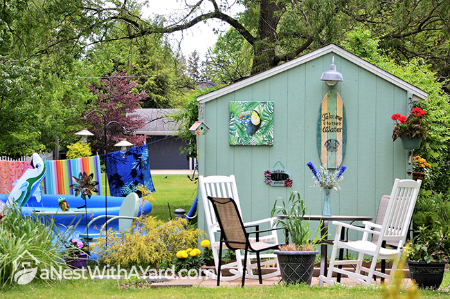 Surf's Up ambience garden shed displaying coastal decors, and tropical illustrations