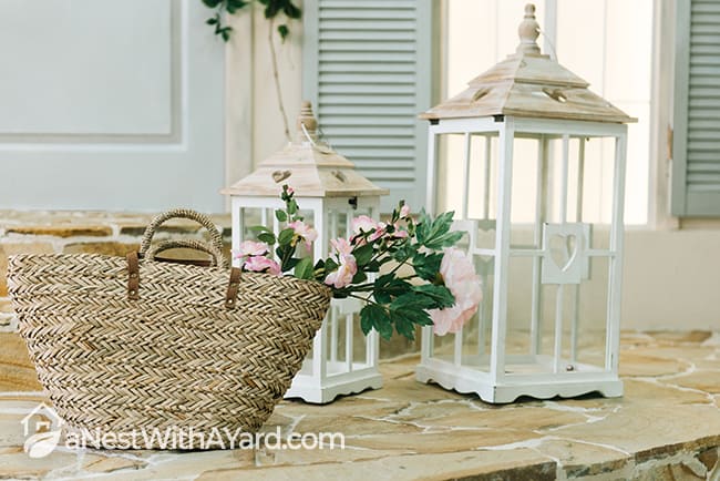 Wicker basket and white lanterns as porch decor