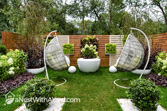 Symmetrical decor in the garden with hanging chairs