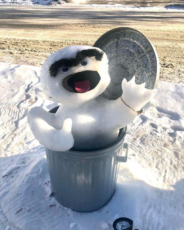 A snowman coming out of a garbage bin