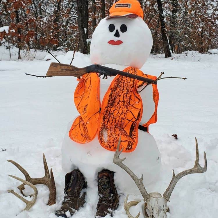 Snowman decorated with hunting gear