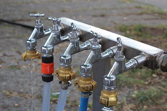 Garden faucets with garden hoses attached to them