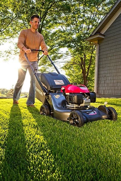 A man using a honda lawn mower
