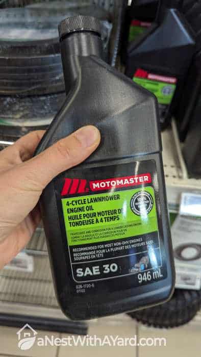 A bottle of lawn mower engine oil