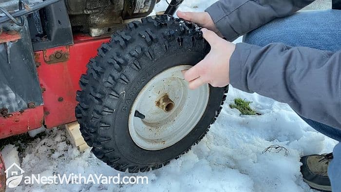Changing the wheel of snow blower