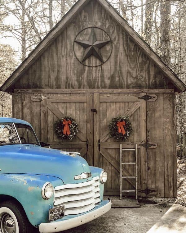 An old style garage with an old model car