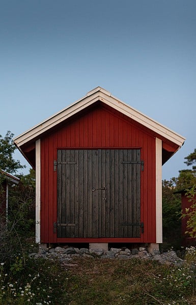 A wooden shed in red and white paint